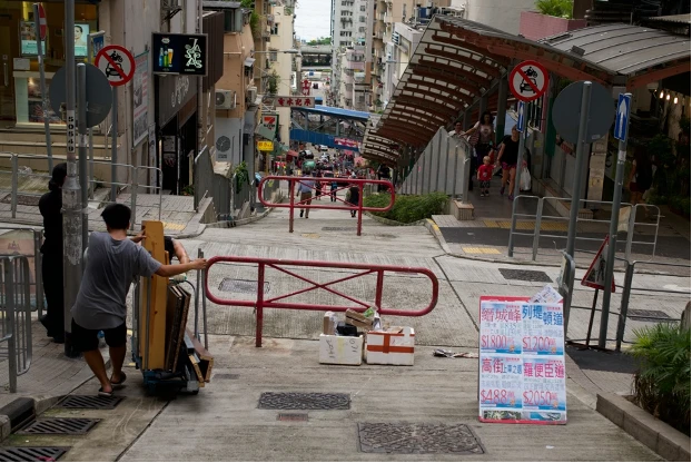 圖7 西營盤正街上的戶外扶梯系統：連接第三街、高街和般含道； 2017 年景致。「西營盤」一詞有著軍營的印記，是英軍早年登陸並築營之地，其在二戰後到約2000年所經歷變遷的研究和歷史照片，可見《地方感：香港砵甸乍街以西》（A Sense of Place: Hong Kong West of Pottinger Street)一書。（Tieben et al. 2008）2013年正街扶梯系統的興建和2015年地下鐵路西營盤站的落成，對社區又有另一波的影響。-圖片